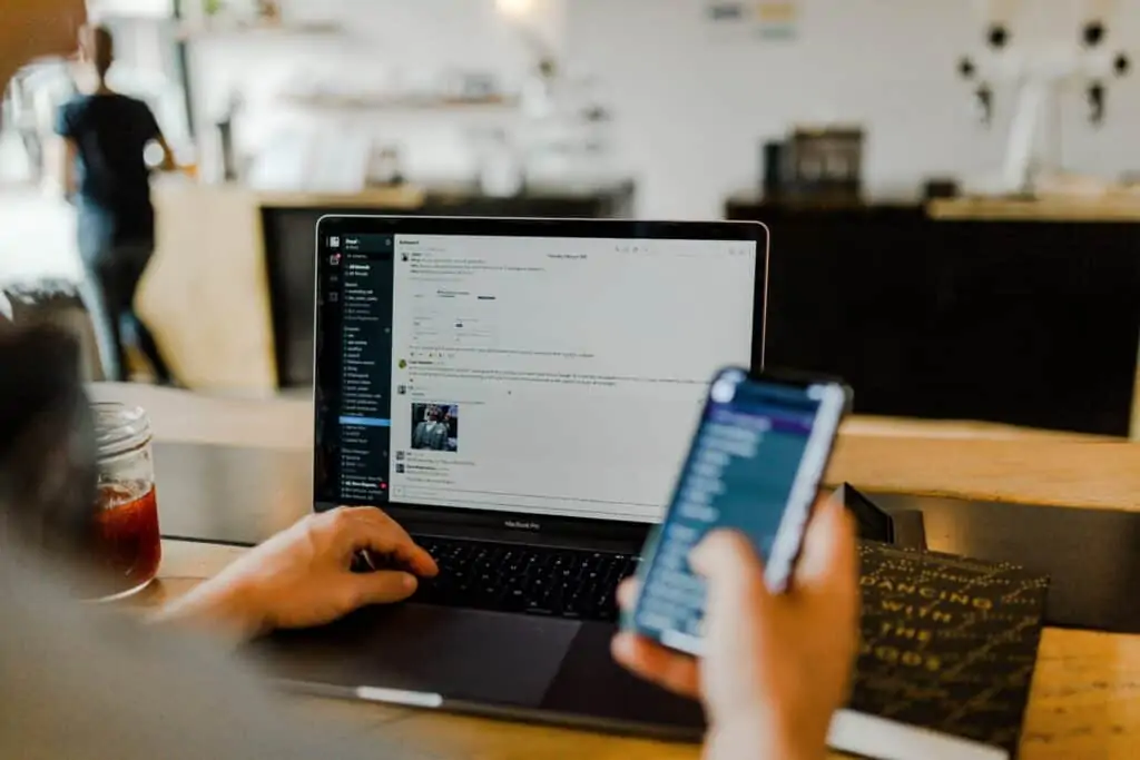 person using laptop and phone